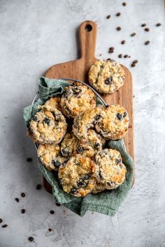 blueberry muffins on a wooden cutting board