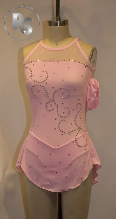 a mannequin wearing a pink leotard with sequins on it