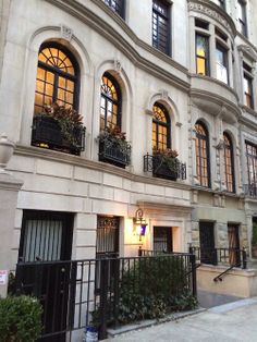 an apartment building with many windows and balconies on the outside, along with wrought iron railings