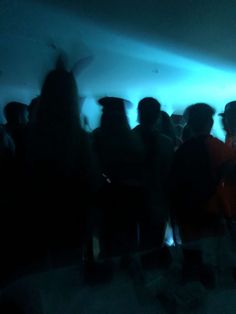 a group of people standing in a dark room