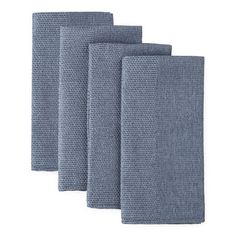 four blue towels folded on top of each other in three different sizes and colors,