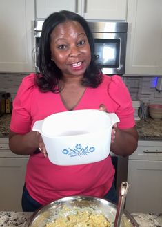 a woman holding a bowl with food in it