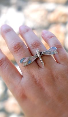 This fabulously organic-looking ring is entirely made of sterling silver (925) with mother of pearl inlays. This beautiful ring is finely handmade, with lots of details, the wings move with your movements. The perfect nature lover gift. The dragonfly's wings measure almost 1 7/8'' (4.8 cm). The ring is one of a kind and is a US size 8. If you don't know your ring size, please check this site: http://www.weddingbandsuperstore.com/ringsize.html More sea treasures coming up, and we will gladly make the custom order to your wishes and dreams with sea treasures! All metal is nickel and lead free. Two shipping options: Registered airmail takes 15 - 30 days on average,it is cheap and safe but slow. TNT which takes 5-7 days to arrive. PLEASE LEAVE YOUR PHONE NUMBER DURING CHECKOUT if you want this Silver Sterling Silver Enamel Ring With Inlay, Sterling Silver Enamel Ring With Inlay For Gift, Wing Ring, Dragonfly Ring, Bold Statement Jewelry, Dragonfly Wings, Mother Of Pearl Inlay, Body Adornment, Pearl Inlay