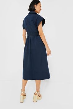 Elegant in its simplicity, the structured and ultra-ladylike Navy Chloe Dress is done in a textured cotton-blend fabric that is sure to turn heads for its design details. The moire pattern throughout and trapunto stitching on the sleeves, placket, and hemline complete this midi moment, making it feel extra special with minimal effort. Pair with heels or flats, sunnies or statement earrings, for day or night, and rest assured that you look fabulous! Spread collar Short wing sleeves Button front p Modern A-line Cotton Dress, Modern Fitted Cotton Dresses, Elegant Cotton Dress For Work, Elegant Cotton Workwear Dresses, Elegant Cotton Dress With Pleated Waist, Modern Cotton Midi Dress, Modern Structured Midi Dress, Cotton Workwear Dress With Pleated Waist, Cotton Dresses With Pleated Sleeves For Daywear