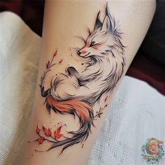 a woman's leg with a tattoo of a fox and leaves on the side