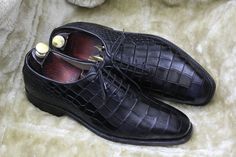 Bespoke Pure Handmade Alligator Textured Black Color Genuine Leather Lace Up Shoes For Men Product Details: Material: Alligator Textured Genuine Leather Upper: Crafted from genuine leather for a luxurious look and feel. Inner: Lined with soft leather, ensuring comfort throughout the day. Sole: Made of durable leather for long-lasting quality. Heel: Features a leather heel for added elegance. Craftsmanship: Handcrafted: Each pair is meticulously hand-stitched to perfection. Manufacturing Time: Please allow 7-10 business days for our skilled artisans to create your custom shoes. Customization: Size and Color: If you can't find your preferred size or color, send us a message, and we'll tailor-make them for you. Measurement: To ensure the best fit, provide your exact measurements, including fo Black Crocodile Pattern Oxfords For Business, Elegant Black Dress Shoes With Crocodile Pattern, Black Crocodile Pattern Wingtip Oxfords, Black Leather Shoes With Crocodile Pattern For Business, Black Crocodile Pattern Leather Shoes For Business, Black Crocodile Pattern Leather Shoes For Office, Office Leather Shoes With Crocodile Pattern, Black Crocodile Pattern Leather Office Shoes, Black Dress Shoes With Crocodile Pattern