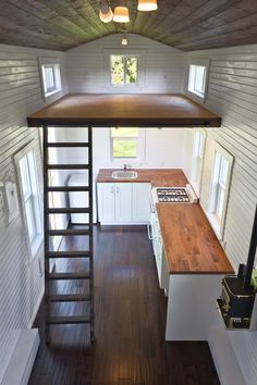 the interior of a tiny house with wood flooring