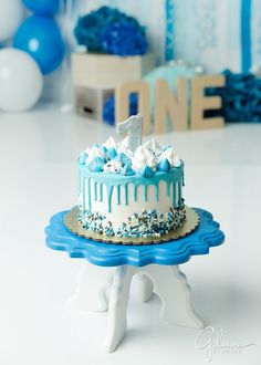 a blue and white birthday cake on a table