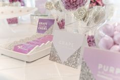 there are candy and candies on the table at this wedding reception in pink and silver