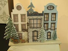 a paper model of a building with trees and sleighs