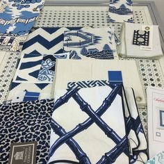 several different types of blue and white cloths on display in a room with tile flooring