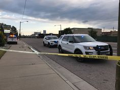 two police cars are parked on the side of the road with tape taped to it