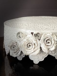 there is a cake decorated with white roses