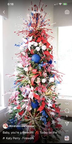 a decorated christmas tree with red, white and blue decorations in the shape of fireworks