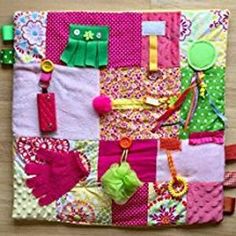 a colorful patchwork quilt with lots of different things hanging on the front and back