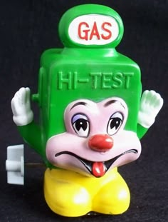 a toy gas pump sitting on top of a black surface