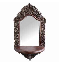 an ornate wooden shelf with mirror on top