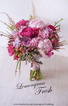 a bouquet of pink and purple flowers in a vase