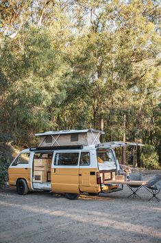 an old van is parked next to a picnic table