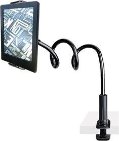 a computer monitor is attached to a black metal pole with a clip on the arm