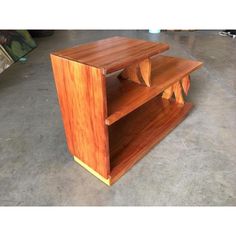 a wooden shelf sitting on top of a cement floor