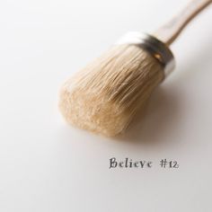 a close up of a brush with the word believe on it's bottom corner