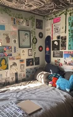 a bedroom with a skateboard on the wall and pictures all over the walls above it