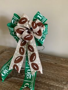 a football themed hair bow on top of a wooden table