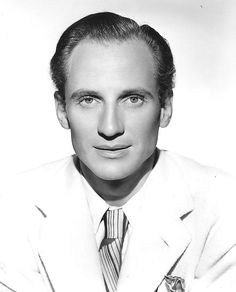 an old black and white photo of a man in a suit with a tie on