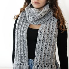 a woman wearing a gray knitted scarf