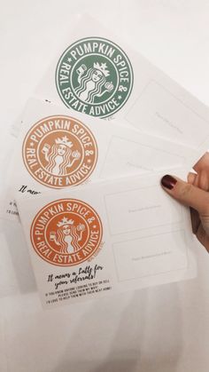 someone is holding some stickers on top of their envelopes that have starbucks logos on them