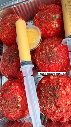 some food is in a plastic container next to a syringe and a bottle