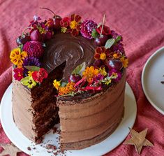 there is a chocolate cake with flowers on the top and one slice missing from it