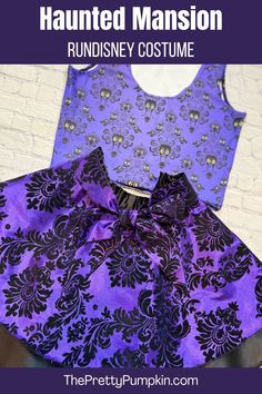 a purple and black dress sitting on top of a table