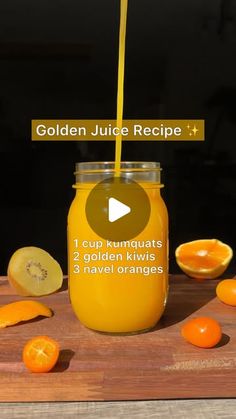 a jar filled with liquid sitting on top of a wooden cutting board next to sliced oranges