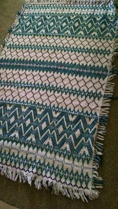 a green and white rug on the floor