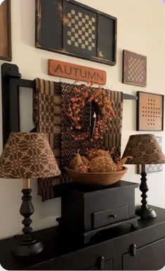 a table topped with lamps and pictures on the wall