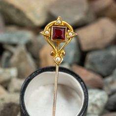 This fabulous old stick pin features a square cut red glass gem with seed pearl accents. The red glass shows some chips and abrasion. Aquamarine Jewelry, Glass Gems, Stick Pins, Seed Pearl, Square Cut, Hat Pins, March Birth Stone, Red Glass, High Quality Jewelry