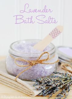 lavender salt in a glass jar with a wooden spoon next to it on a table