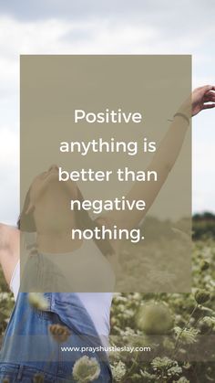 a woman standing in a field with her arms up and the words positive anything is better than negative nothing