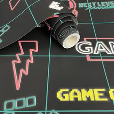 a close up of a game board with the word game on it and a roll of tape