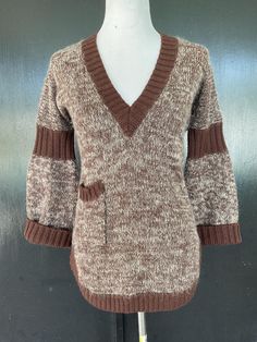 1970s Vamp by Koret pullover sweater. Brown and white acrylic. Solid brown areas are ribbed. Brown and white area has a fuzzy angora type feel. Small pocket on right front. Measurements  36-38" bust 30" midriff 36" hem 29" length 26" sleeves Delightful sweater shows very well with minimal to no wear. Brown Chenille Sweater, Brown Knit V-neck Sweater For Winter, Brown Long Sleeve V-neck Sweater For Winter, Retro Ribbed Winter Tops, Fitted Brown Knit Top With V-neck, Fitted Brown V-neck Knit Top, Retro Brown Top For Winter, Brown Ribbed Long Sleeve Knit Top, Retro Brown Winter Top