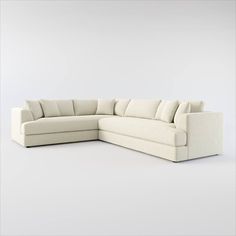 a white sectional couch sitting on top of a white floor