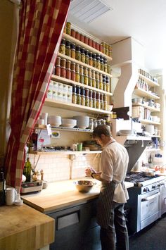 a man standing in a kitchen preparing food