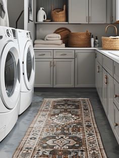 a washer and dryer sitting in a room next to each other on top of a rug