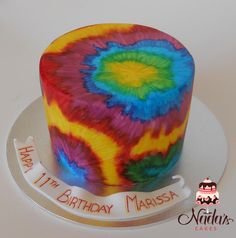 a tie - dyed birthday cake with a happy 11th birthday message