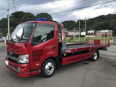 a red truck is parked on the side of the road