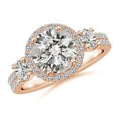 a rose gold engagement ring with two round diamonds on the band and an oval center stone