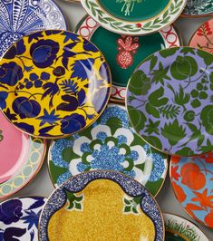 many colorful plates are stacked on top of each other in the same pattern and color