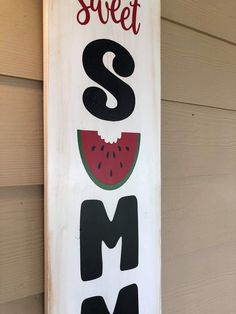 a wooden sign that says sweet and has watermelon slices on the front side